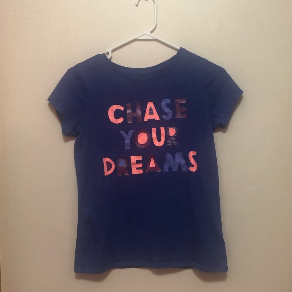 A dark blue pajama shirt that is extra large in kids.